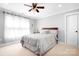 Bedroom featuring plush carpeting, a ceiling fan, and a window at 164 Crooked Branch Way, Troutman, NC 28166