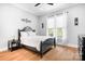 Bright bedroom with hardwood floors, natural light, and black furniture at 164 Crooked Branch Way, Troutman, NC 28166