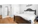 Bedroom featuring a bed with white linens and hardwood floors at 164 Crooked Branch Way, Troutman, NC 28166