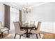 A well lit dining room including a wood table, six chairs, and crown molding at 164 Crooked Branch Way, Troutman, NC 28166