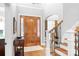 A view of the foyer, the front door and a staircase leading up to the second floor at 164 Crooked Branch Way, Troutman, NC 28166