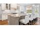Kitchen island including white barstools and granite countertops at 164 Crooked Branch Way, Troutman, NC 28166