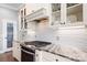 The kitchen has updated stainless appliances, white cabinets and granite countertops at 164 Crooked Branch Way, Troutman, NC 28166