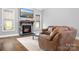 Cozy living room with a stone fireplace, a mounted TV, and comfortable seating at 164 Crooked Branch Way, Troutman, NC 28166