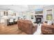 Spacious living room featuring a fireplace, hardwood floors, and an open concept kitchen at 164 Crooked Branch Way, Troutman, NC 28166