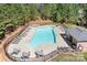 Aerial view of a community pool surrounded by lounge chairs and lush greenery at 164 Crooked Branch Way, Troutman, NC 28166