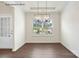 Dining area with modern light fixture and large window letting in natural sunlight at 1650 Troon Dr, Salisbury, NC 28144