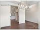 Open dining area with modern light fixture and views into the kitchen at 1650 Troon Dr, Salisbury, NC 28144