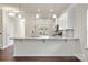 Open-concept kitchen with granite countertops, white cabinets, and a breakfast bar area at 1650 Troon Dr, Salisbury, NC 28144