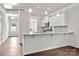 Modern kitchen featuring granite countertops, white cabinets, and stainless steel appliances at 1650 Troon Dr, Salisbury, NC 28144
