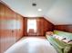 Finished attic featuring wood paneling and a window, offering a unique and comfortable living space at 167 Cedar Ln, Troutman, NC 28166