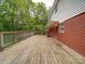 Expansive wooden deck offering ample space for outdoor seating and entertaining with lush trees in background at 167 Cedar Ln, Troutman, NC 28166