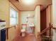 Compact bathroom features a toilet, sink, and adjacent staircase, providing essential amenities in a functional layout at 167 Cedar Ln, Troutman, NC 28166