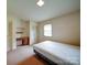 A bright bedroom featuring a desk, closet, and a window with blinds, creating a comfortable space at 167 Cedar Ln, Troutman, NC 28166