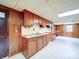 Cozy kitchen with wooden cabinets, stainless steel sink, and tile flooring offers a functional space for culinary endeavors at 167 Cedar Ln, Troutman, NC 28166