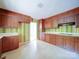 Traditional-style kitchen featuring classic wood cabinets, colorful wallpaper, and functional layout at 167 Cedar Ln, Troutman, NC 28166
