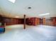 Spacious living room featuring wood paneling and tile flooring, offering a versatile space for relaxation and entertainment at 167 Cedar Ln, Troutman, NC 28166