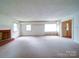 Bright and airy living room with a cozy fireplace and large windows offering natural light at 167 Cedar Ln, Troutman, NC 28166