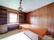 An organized office space with custom wood cabinets, built-in shelving, and a large wooden desk at 167 Cedar Ln, Troutman, NC 28166