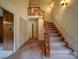 Grand foyer with a carpeted staircase and wood railings, creating an inviting entrance at 167 Cedar Ln, Troutman, NC 28166