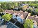 Community aerial view showing condos, parking, and lush greenery, with various rooftops and tree coverage at 17143 Red Feather Dr, Charlotte, NC 28277