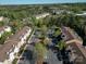 Aerial shot of the condo buildings with ample parking and lush green landscaping at 17143 Red Feather Dr, Charlotte, NC 28277