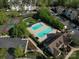 Aerial image of the community pool, tennis court, clubhouse, landscaping, and parking area at 17143 Red Feather Dr, Charlotte, NC 28277