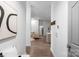 Inviting hallway with hardwood floors leading to the living area, featuring stylish decor and neutral tones at 17143 Red Feather Dr, Charlotte, NC 28277