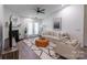 Bright living room with fireplace, modern decor, neutral colors, and french doors at 17143 Red Feather Dr, Charlotte, NC 28277