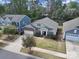 Aerial view of a home with a two-car garage, manicured lawn, and charming front porch at 1718 Still River Way, Fort Mill, SC 29708