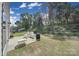 Backyard patio with furniture, lush green grass and trees at 1718 Still River Way, Fort Mill, SC 29708
