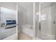 Bright bathroom boasts a separate shower and soaking tub with a view into an adjacent bedroom at 1718 Still River Way, Fort Mill, SC 29708