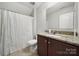 Bathroom with granite countertop vanity and shower with white curtain at 1718 Still River Way, Fort Mill, SC 29708