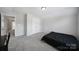 A bedroom with carpet and light walls has a large closet at 1718 Still River Way, Fort Mill, SC 29708