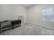 Small bedroom with a closet, window, and end table with storage is painted a modern neutral color at 1718 Still River Way, Fort Mill, SC 29708