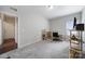 Carpeted bedroom features neutral paint, a desk beneath a window, and wire shelves for storage at 1718 Still River Way, Fort Mill, SC 29708
