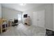 Carpeted bedroom with a desk, shelving and a large closet is painted a modern neutral color at 1718 Still River Way, Fort Mill, SC 29708