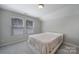 Bedroom with carpet, a large bed and two windows with blinds at 1718 Still River Way, Fort Mill, SC 29708