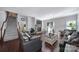 Cozy living room with a stone fireplace, hardwood floors, neutral decor, and plenty of seating at 1718 Still River Way, Fort Mill, SC 29708