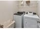 Functional laundry room with modern washer and dryer units and overhead shelving at 1726 Braemar Village Dr, Monroe, NC 28110