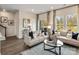 Bright living room with hardwood floors, stylish sofas, and large windows at 1726 Braemar Village Dr, Monroe, NC 28110