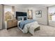 Well-lit primary bedroom features a plush bed, elegant decor, and large windows offering abundant natural light at 1726 Braemar Village Dr, Monroe, NC 28110