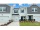 Charming townhome features a one-car garage, landscaped yard, and stylish gray and white color scheme at 1741 Braemar Village Dr, Monroe, NC 28110
