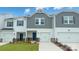 Charming townhome with well-manicured lawn, attached garage, and inviting blue front door at 1743 Braemar Village Dr, Monroe, NC 28110