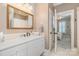 Bathroom featuring marble countertops, white cabinets and a large framed mirror at 1849 Oakmont Dr, Denver, NC 28037