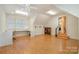 Bonus room featuring wood floors, storage, work area, and lots of natural light at 1849 Oakmont Dr, Denver, NC 28037