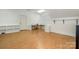 Bright bonus room with wood flooring, shelving, and work area with lots of natural light at 1849 Oakmont Dr, Denver, NC 28037