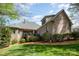 Stunning backyard view of a well-maintained brick home, featuring a lovely patio and landscaped lawn at 1849 Oakmont Dr, Denver, NC 28037