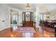 Inviting foyer with gleaming hardwood floors, elegant rug, and views into the dining and living areas at 1849 Oakmont Dr, Denver, NC 28037
