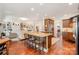 An open kitchen flows into a living room area with dark wood floors and a granite topped kitchen island with seating at 1849 Oakmont Dr, Denver, NC 28037